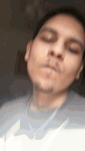 a close up of a man 's face with his eyes closed and his mouth open