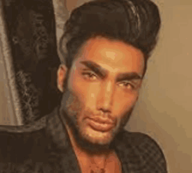 a close up of a man 's face with a beard wearing a jacket and necklace .