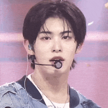a close up of a person wearing a microphone and earphones .