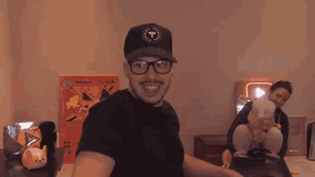 a man wearing a hat and glasses is standing in front of a neon sign that says youtube