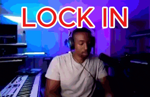 a man wearing headphones is sitting in front of a keyboard with the words lock in above him