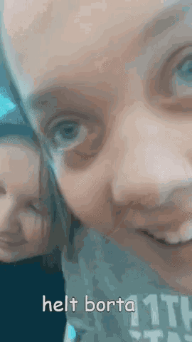 a close up of a girl 's face with the words helt borta on the bottom right