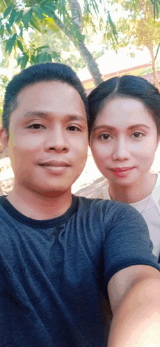 a man and a woman are posing for a selfie together