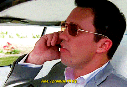 a man wearing sunglasses and a suit is talking on a cell phone and says fine i promise i 'll try