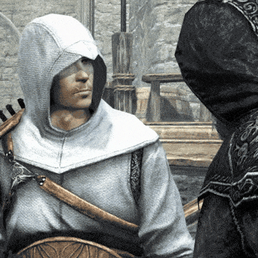 a man in a white hoodie stands next to another man