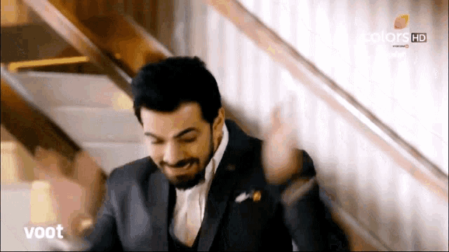 a man in a suit is standing on a set of stairs with the words voot on the bottom of the screen