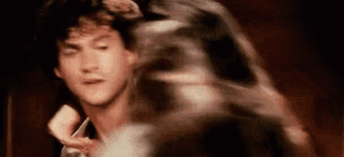 a blurry picture of a man 's face with a woman 's arm around him .