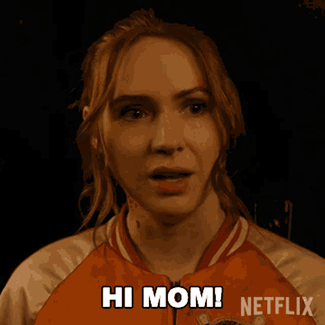 a woman in an orange jacket says hi mom on netflix