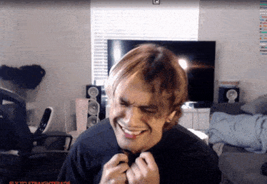 a man is laughing in front of a screen that says fly to straighttrade on it