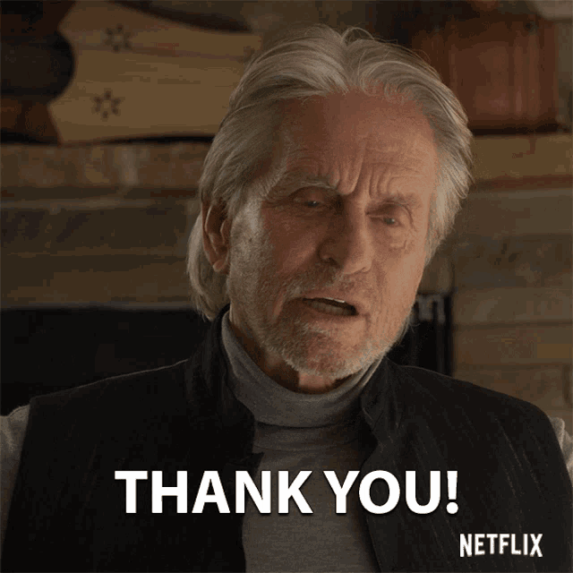 a man with gray hair and a beard is saying thank you