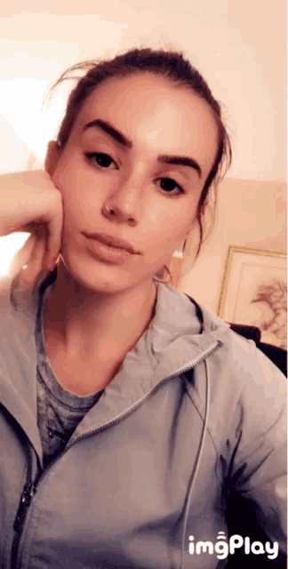 a woman 's face is shown in a gif with the words imgplay below it
