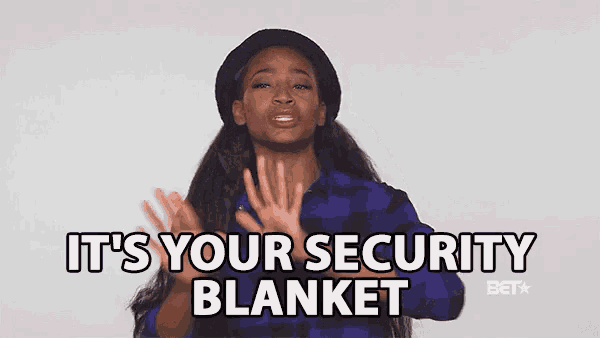 a woman says " it 's your security blanket " in front of a white wall