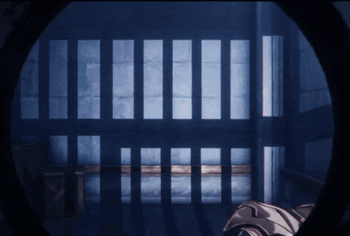 a prison cell with bars and a light coming through them