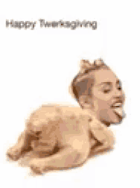 a picture of miley cyrus laying on a turkey with her tongue out