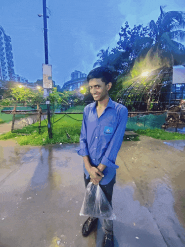 a man in a blue shirt with a sticker on his pocket that says ' a '