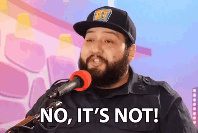 a man with a beard is singing into a microphone with the words no it 's not