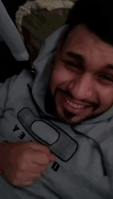 a man wearing a hoodie that says jao on it is smiling