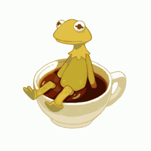 a kermit the frog sits on top of a cup of coffee