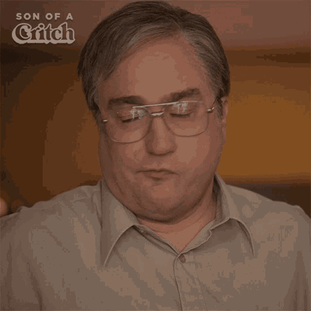 a close up of a man 's face with the words son of a grifch behind him