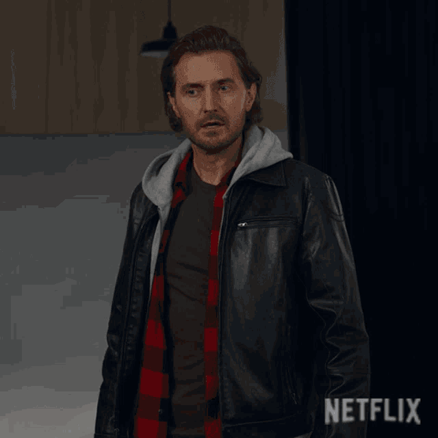 a man wearing a leather jacket says uh yeah