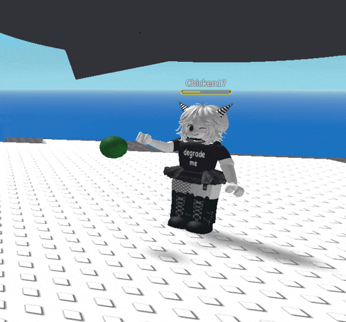 a girl in a degrade me shirt is holding a green ball in a video game