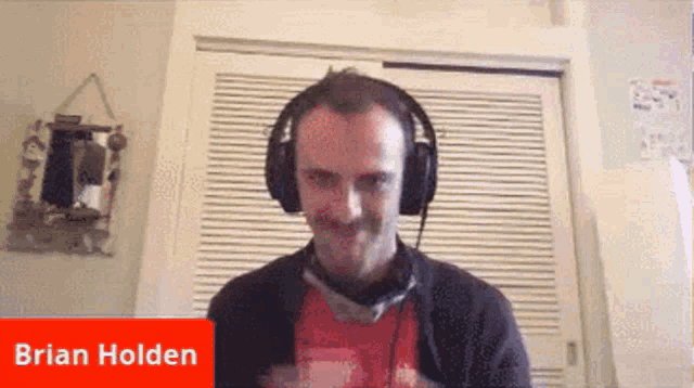 a man wearing headphones has the name brian holden on the bottom