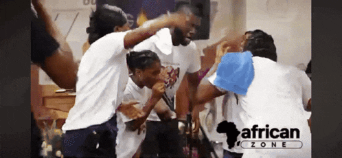 a group of people are dancing in front of an african zone sign