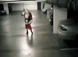 a man dressed as santa claus is standing in a parking garage