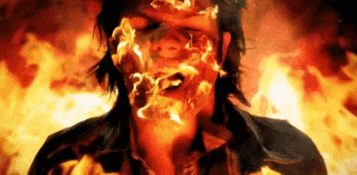 a close up of a person 's face with fire coming out of it .