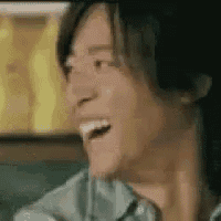 a close up of a person 's face with their mouth open and a smile on their face .