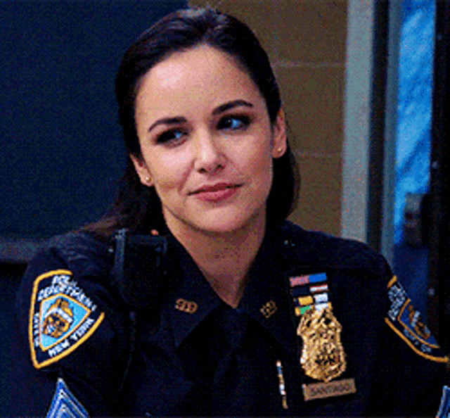 a woman in a police uniform has a patch on her arm that says new york police department