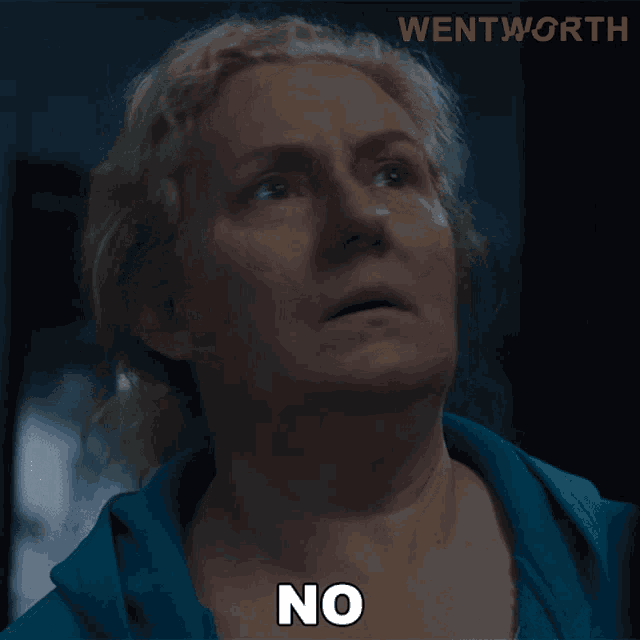 a woman in a blue shirt says no in front of a sign that says wentworth