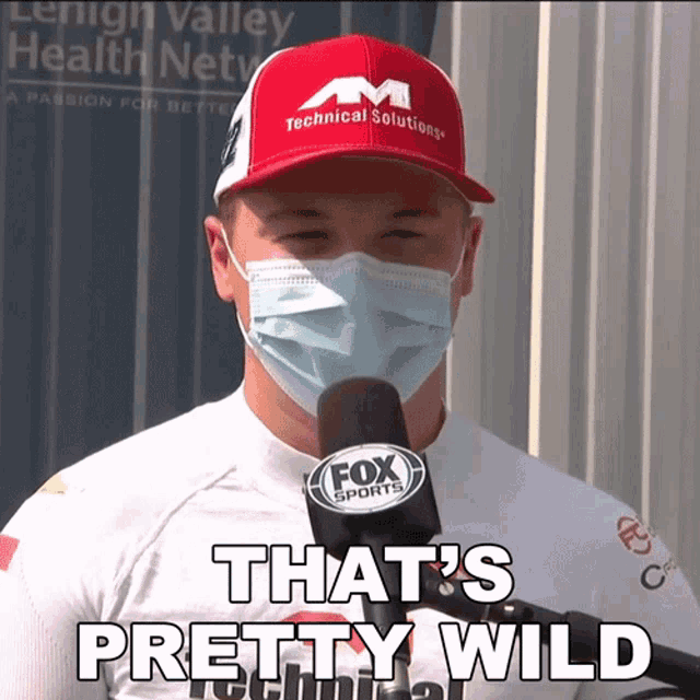 a man wearing a mask and a fox sports hat