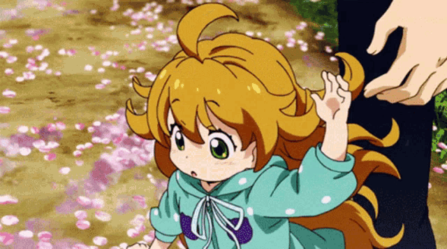 a little girl in a blue hoodie is waving at someone