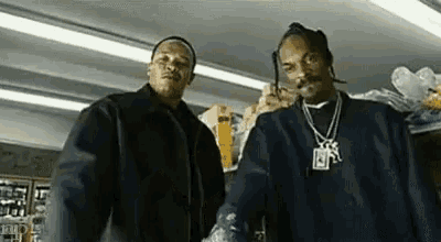 two men are standing next to each other in a store .