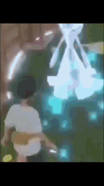 a blurry picture of a person standing in front of a giant statue