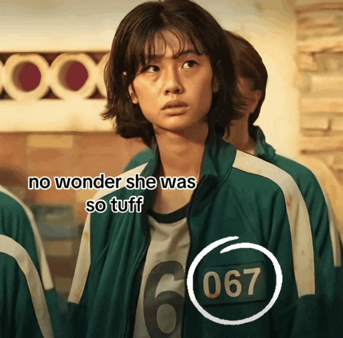 a woman wearing a green jacket with the number 067 on it