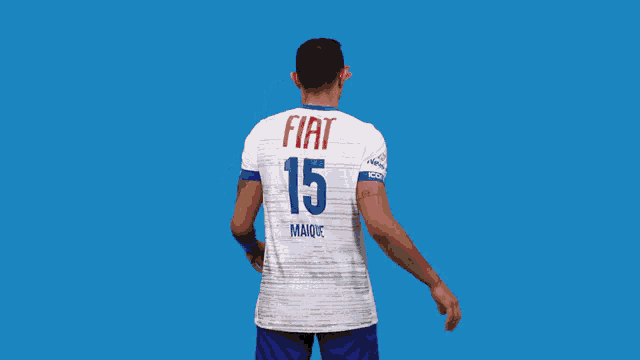a man wearing a white shirt with fiat 15 maique on the back