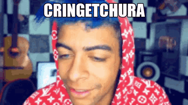 a man with blue hair wearing a red louis vuitton hoodie
