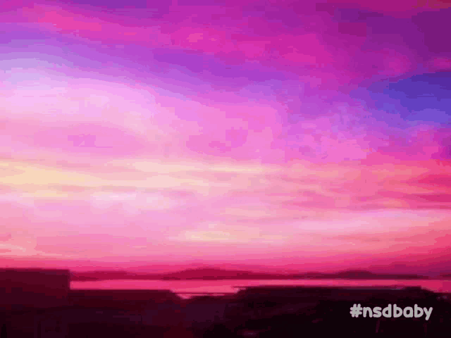 a pink and purple sunset over a body of water