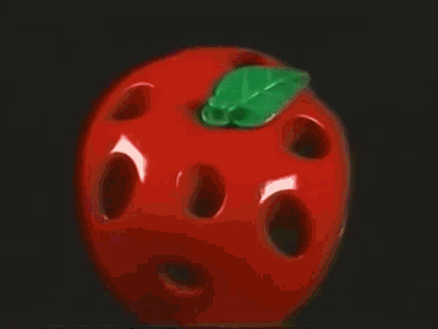 a red apple with a green leaf on it