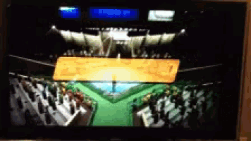 a blurred image of a stadium with a few people watching