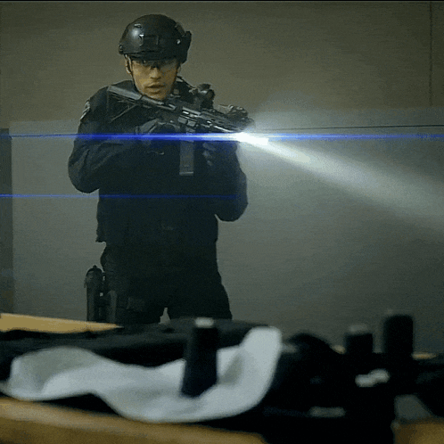 a man in a helmet is holding a gun