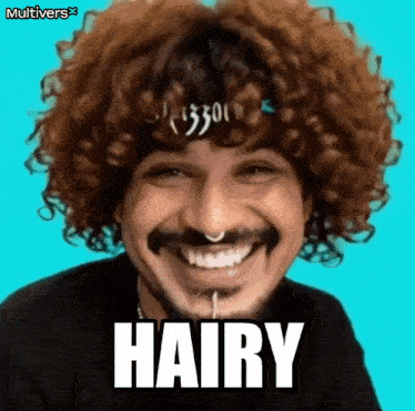 a man with curly hair and a nose ring is smiling with the word hairy written on his face .