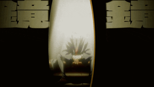 a shadow of a person is cast on a wall with chinese writing behind it
