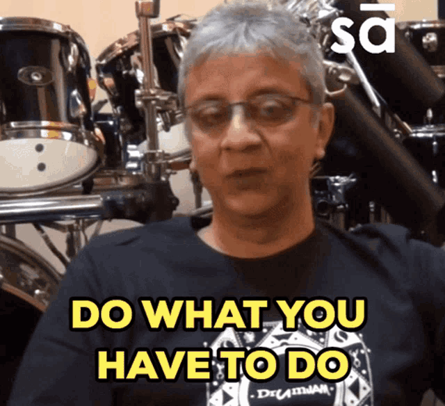 a man wearing glasses and a black shirt says do what you have to do
