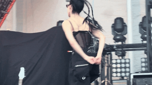 a woman in a black top with the letter g on the back of it