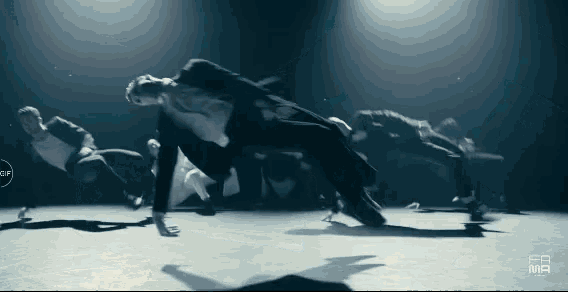 a group of dancers are performing in a dark room and the letters fb are on the bottom
