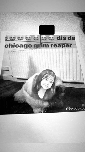 a black and white photo of a girl in front of a chicago grim reaper
