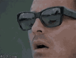 a man wearing sunglasses with the words it 's finger lickin ' good on them